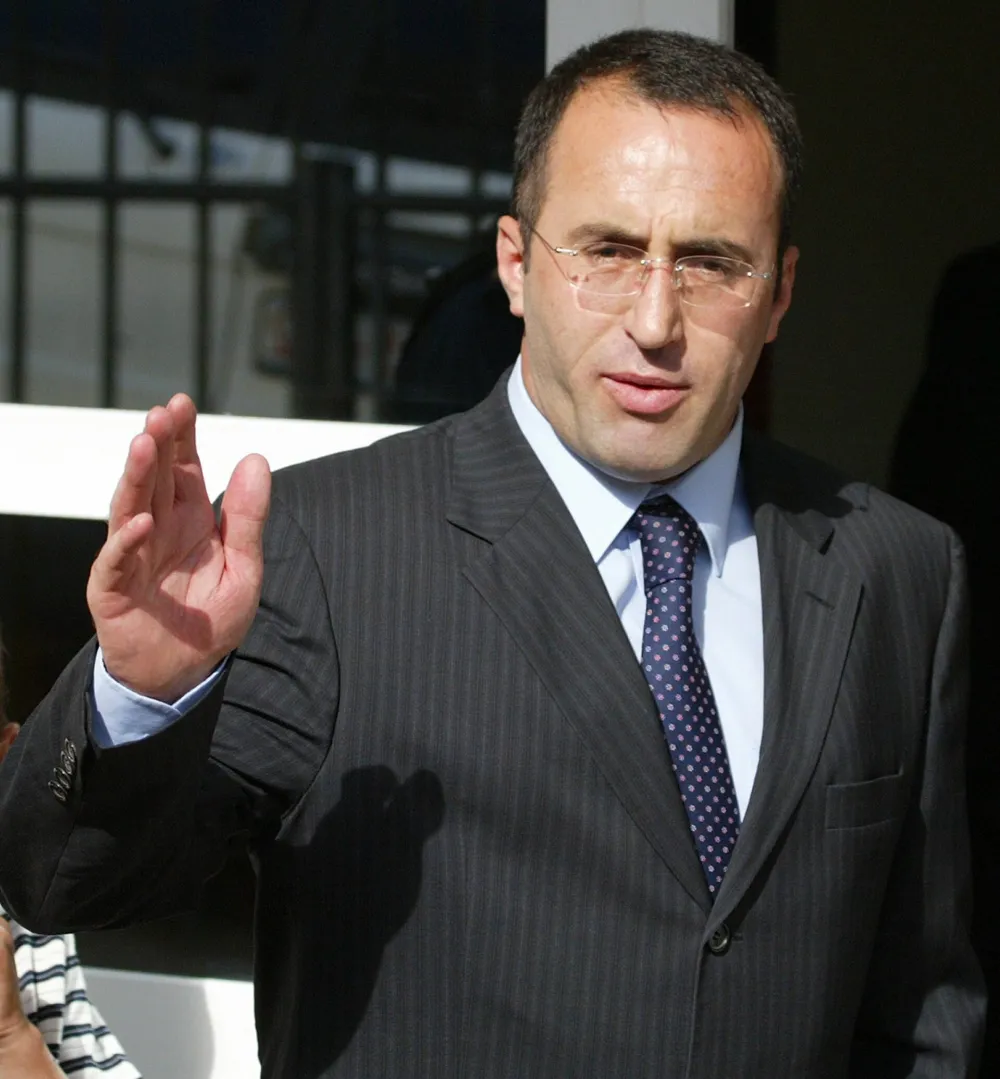 Former Kosovo prime minister Ramush Haradinaj arrives at his home in Pristina, after been released by the U.N. war crimes trial in The Hague until the start of his trial, June 9, 2005. REUTERS/Hazir Reka.