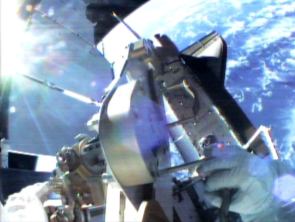 Astronauts left the shuttle Endeavour, pictured below, and made a spacewalk to fix a limp wing on the International Space Station, December 7, 2000. Endeavour's crew installed the solar array on the station on December 3, but one of two wings lined with thousands of photoelectric cells failed to pull taut when it was deployed.    REUTERS/NASA