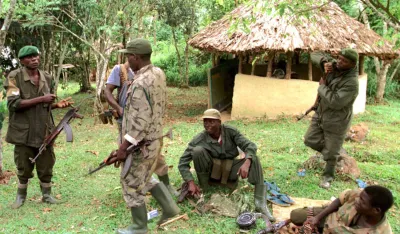KAM07:UGANDA-TOURISTS:BWINDI,UGANDA,4MAR99 - Ugandan soldiers guard the damaged and burnt remains March 3 of one of the three camps in Uganda's Bwindi national Park were 31 foreign tourists were abducted and eight butchered to death on Monday. The tourists had travelled to the park for an adventure holiday tracking rare mountain gorillas. Fifteen of the Hutu rebels have been killed in a Rwanda army ambush, a senior Ugandan military officer said March 4. gm/Photo by Simon Denyer REUTERS