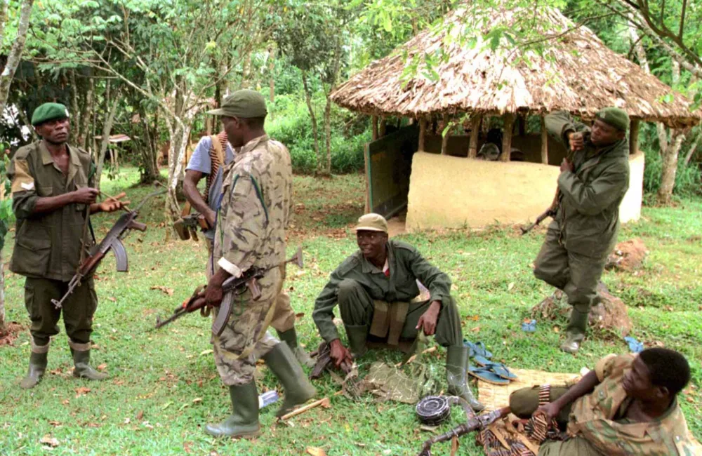 KAM07:UGANDA-TOURISTS:BWINDI,UGANDA,4MAR99 - Ugandan soldiers guard the damaged and burnt remains March 3 of one of the three camps in Uganda's Bwindi national Park were 31 foreign tourists were abducted and eight butchered to death on Monday. The tourists had travelled to the park for an adventure holiday tracking rare mountain gorillas. Fifteen of the Hutu rebels have been killed in a Rwanda army ambush, a senior Ugandan military officer said March 4. gm/Photo by Simon Denyer REUTERS