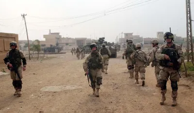 U.S. Army's 1st Infantry Division soldiers conduct a raid in Samarra Thursday Dec. 18, 2003. On Wednesday, the 4th Infantry started a new series of raids, dubbed Operation Ivy Blizzard, in Samarra along with Iraqi security forces. (AP Photo/Khalid Mohammed)