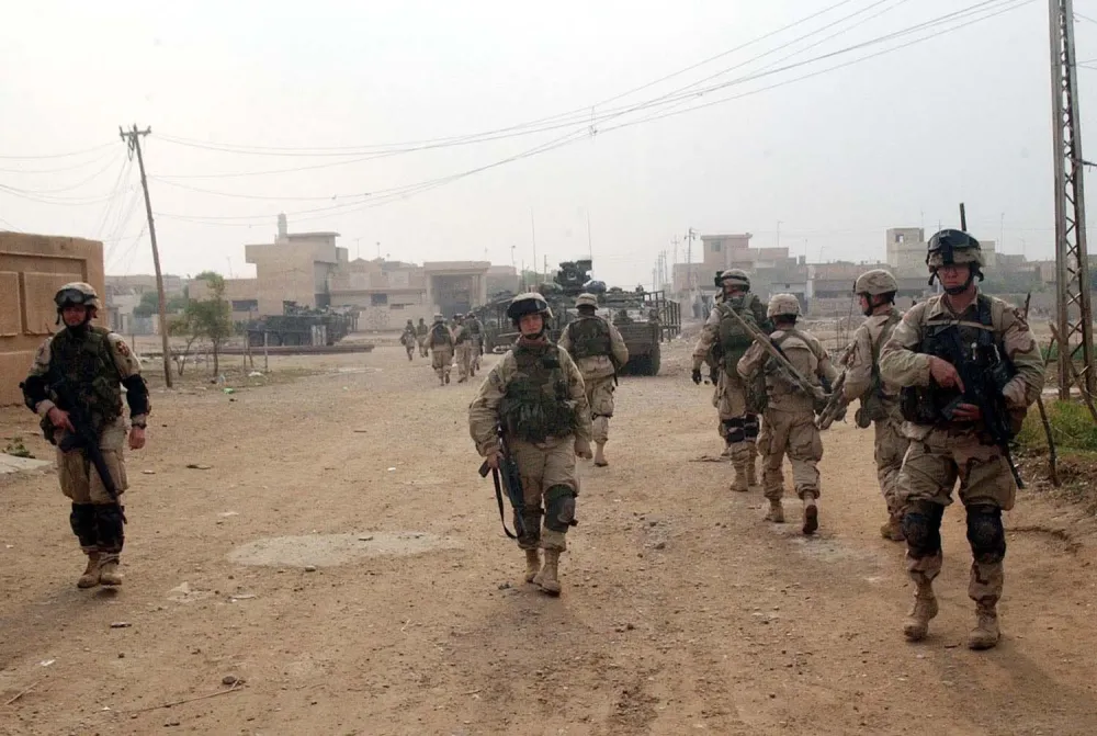 U.S. Army's 1st Infantry Division soldiers conduct a raid in Samarra Thursday Dec. 18, 2003. On Wednesday, the 4th Infantry started a new series of raids, dubbed Operation Ivy Blizzard, in Samarra along with Iraqi security forces. (AP Photo/Khalid Mohammed)