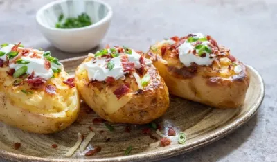 Baked loaded potato with bacon, cheese, sour cream and onion