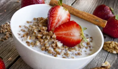 healthy breakfast with fresh strawberries and buckwheat with milk