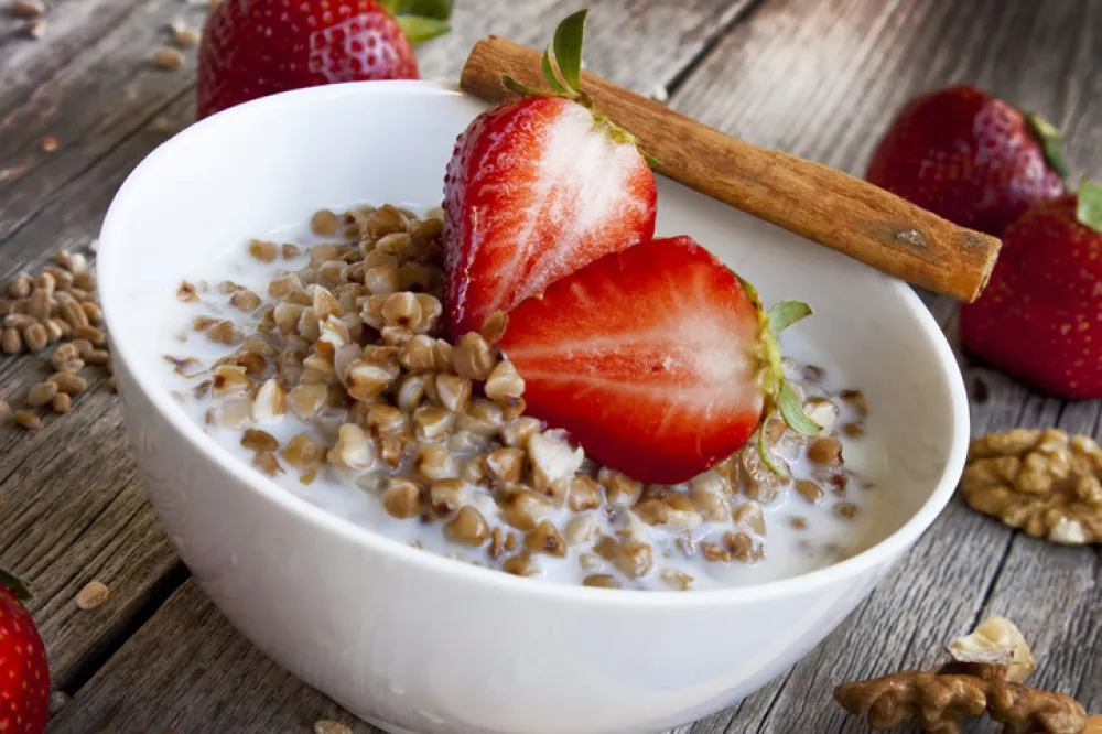 healthy breakfast with fresh strawberries and buckwheat with milk