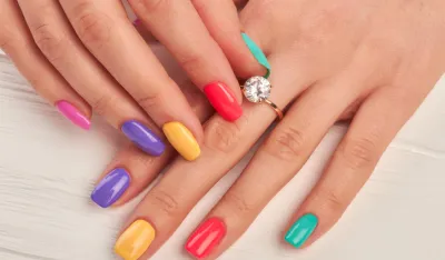 Manicured fingers touching diamond on ring. Engagement ring on female manicured hand. Wedding ring on woman finger.