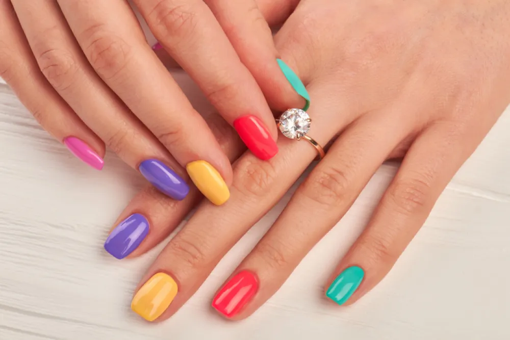 Manicured fingers touching diamond on ring. Engagement ring on female manicured hand. Wedding ring on woman finger.