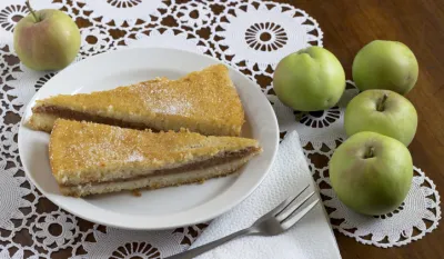 Freshly baked apple pie on wooden table
