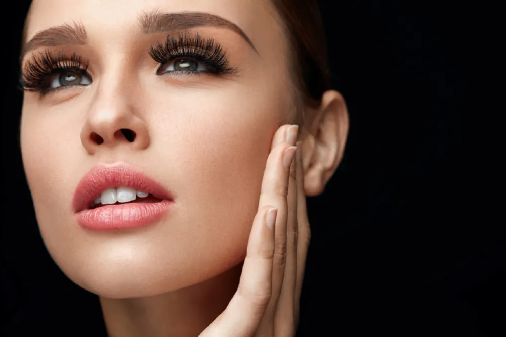 Beauty Woman Face. Portrait Of Beautiful Young Female With Perfect Facial Makeup, Soft Fresh Healthy Skin And Thick Long Black Eyelashes. High Resolution