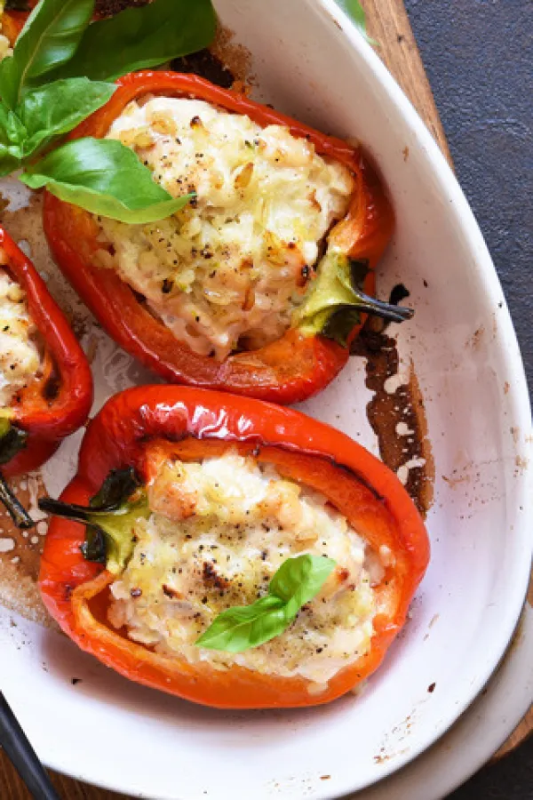 Baked bell pepper with meat and rice on a concrete dark background.