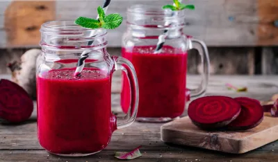 healthy detox beet smoothie with chia seeds in a mason jar on a wooden background