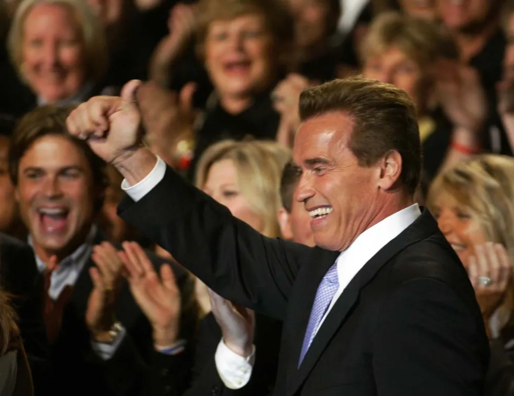 Republican Arnold Schwarzenegger enters a ballroom victory party following his victory in the California gubernatorial recall election in Los Angeles, Tuesday, Oct. 7, 2003. (AP Photo/Stephan Savoia)