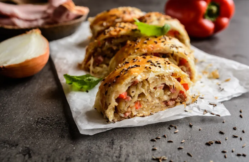 Savory strudel stuffed with sour cabbage, bacon, red pepper and onion