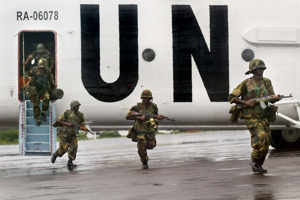 The first of the Economic Community of West African States Mission in Liberia (ECOMIL) Nigerian peacekeeping troops arrive by UN helicopter at Robertsfield airport near the Liberian capital Monrovia Monday Aug 4, 2003. (AP Photo/Ben Curtis)