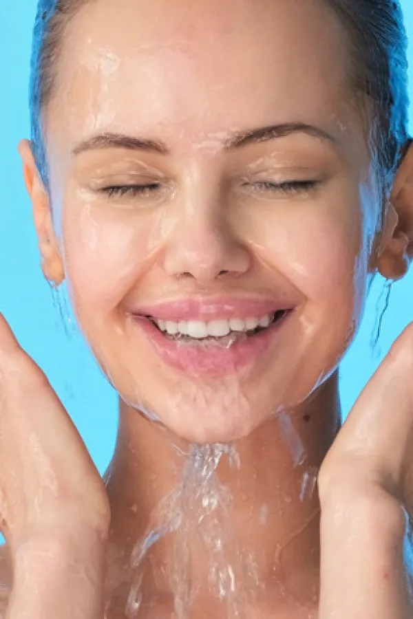 Woman washing her clean face with water. Closeup face of an Young girl washing face with water. Skin care hygiene procedure. 	 <br>