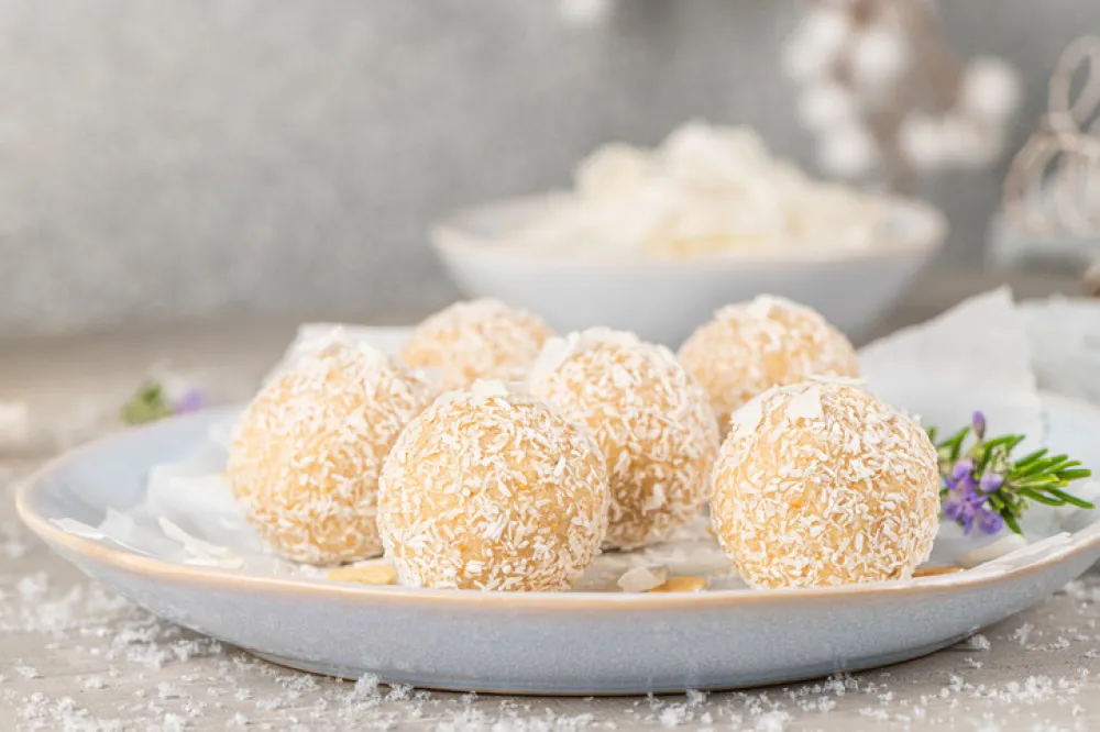 Homemade sweet white chocolate and coconut in a plate. Candy - snowball truffles on a Christmas table