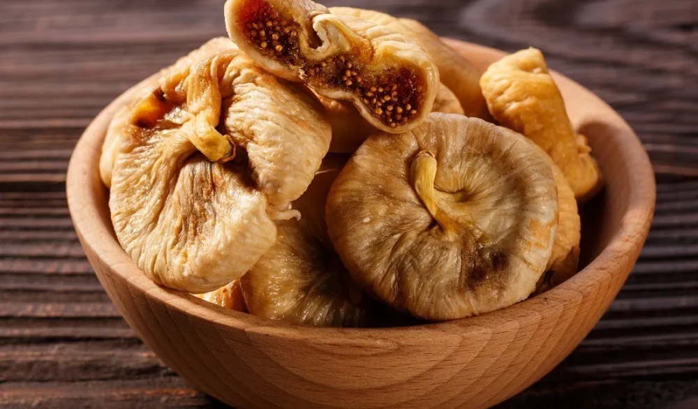 Dried figs on a dark rustic background.