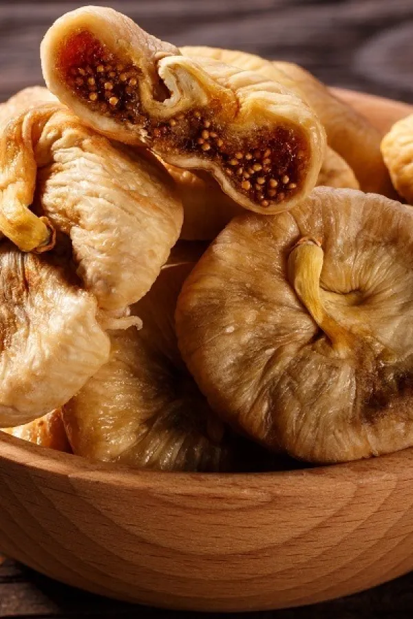 Dried figs on a dark rustic background.