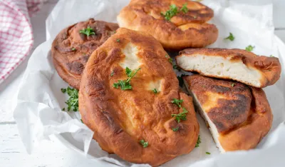 Delicious homemade pan fried langos. Tasty hungarian flatbread made with yeast dough