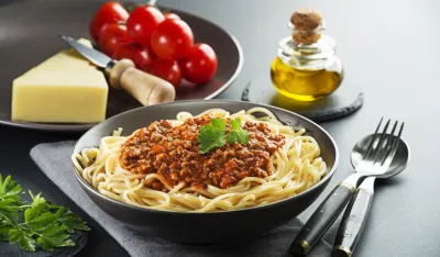 Delicious spaghetti with bolognese sauce served on a black plate