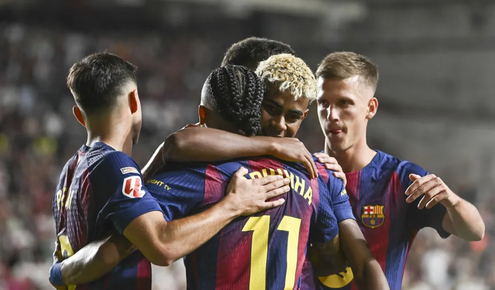 epa12341550 Barcelona's Lamine Yamal celebrates his team's first goal with his teammates during the Spanish LaLiga EA Sports soccer match between Rayo Vallecano and FC Barcelona at Vallecas stadium in Madrid, Spain, 31 August 2025. EPA/Fernando Villar